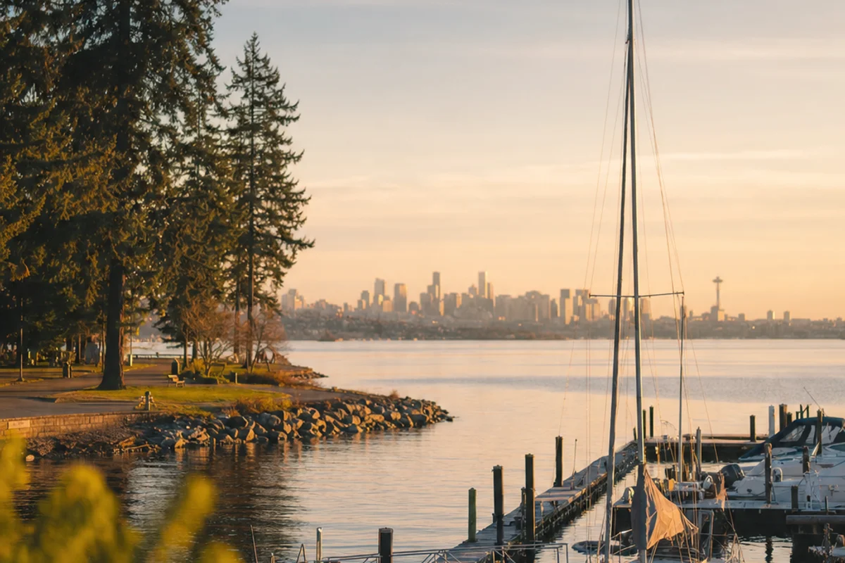 The Kirkland marina on Lake Washington with the Seattle skyline across the water at golden hour